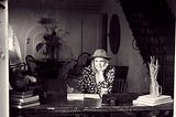 Writer at desk, developing a story.
