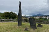 An ancient tombstone dated back 5300 years stands tall against a Southern Taiwan mountain skyline on a cloudy January in 2021