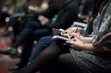 People writing their thoughts during a meeting