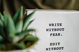 A ceramic sign reads “Write without fear. Edit without mercy.”