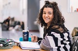 Girl sitting at a desk, smiling