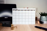 And empty paper calendar of whatever month, with nothing posted on it, on top of a desk