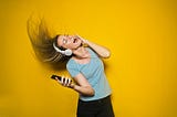 A woman listens to music on headphones