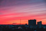 Sunset over a city and its buildings