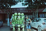 Blow up alien dolls on back of truck