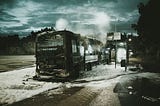 Burnt-out bus standing in front of a bus stop