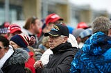 Veteran in a crown of Maga hats
