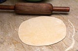 rolled out.A rolling pin with a roti