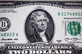 picture of a two dollar bill, which is rare like the author