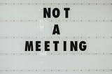 “Not a meeting” on white background.