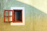 Opened brown window in a yellow/green background.