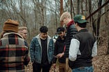 A bunch of teenagers looking at a phone