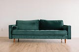 A two seater sofa on a bare wood floor. It is meant to illustrative of a sofa, and not of a Burrow, which is the subject of the article.