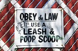 Sign — Obey the Law Use A Leash & Poop Scoop