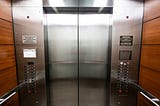 Trapped on the Elevator with Him, and She’s the Dangerous One