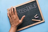 A chalkboard that says impossible, but the “im” is covered to show “possible”