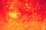 orange red, golden image of liquid with bubbles