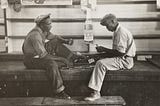 Vintage photo of two working men playing cards