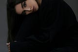 Woman with long dark hair.