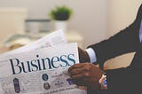 Person reading a business newspaper