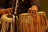 Image of hands playing the tabla, a percussion music instrument