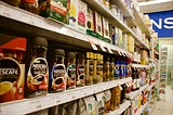 A supermarket shelf full of different brands of coffee