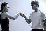 A man and woman giving each other a fist bump.
