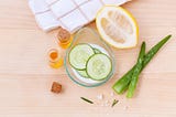 Skincare items with lemon cucumber slices and aloe vera with face oils