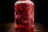 A Kilner jar filled with pickled red chillis