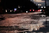 Puddles reflecting streetlights