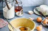 A baking bowl with flour and eggs.