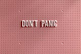 A peg board that says don’t panic on it.