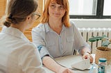 An image of a doctor measuring a patient’s blood pressure.