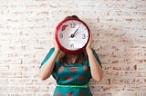 woman holding clock