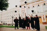 A bunch of students throwing their graduation caps in the air