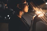 Black women holding rays of light in her hands