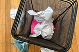 A photo of my waste basket with crumpled up papers