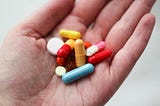 Hand holding pills