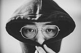 Man hiding the lower half of his face under his sweater