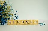 Scrabble tiles spelling out blessed