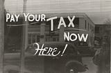 A picture that says to pay your tax here now on a window. You may be able to get $1800 of stimulus from your tax return if you did not receive it in 2020.