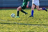 Girls playing soccer.