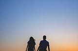 Young couple on the beach holding hands