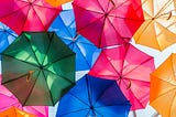 Multicoloured umbrellas suspended in the sky