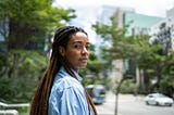 Portrait of a young woman of color outside