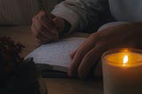 Journalling or writing in warm candlelight