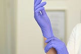 the doctor puts on gloves