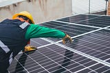 Man fixing solar energy panels