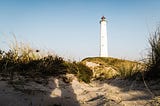 White lighthouse on dunes