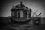 1920s style horse-drawn hearse, black and white